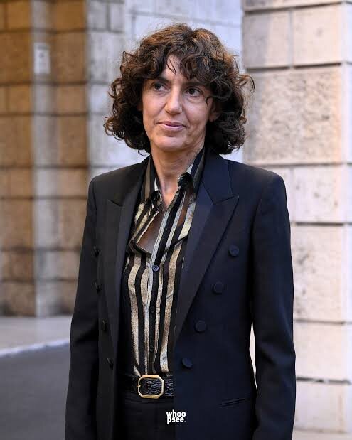 Francesca Bellettini photographed standing outdoors in tailored dress