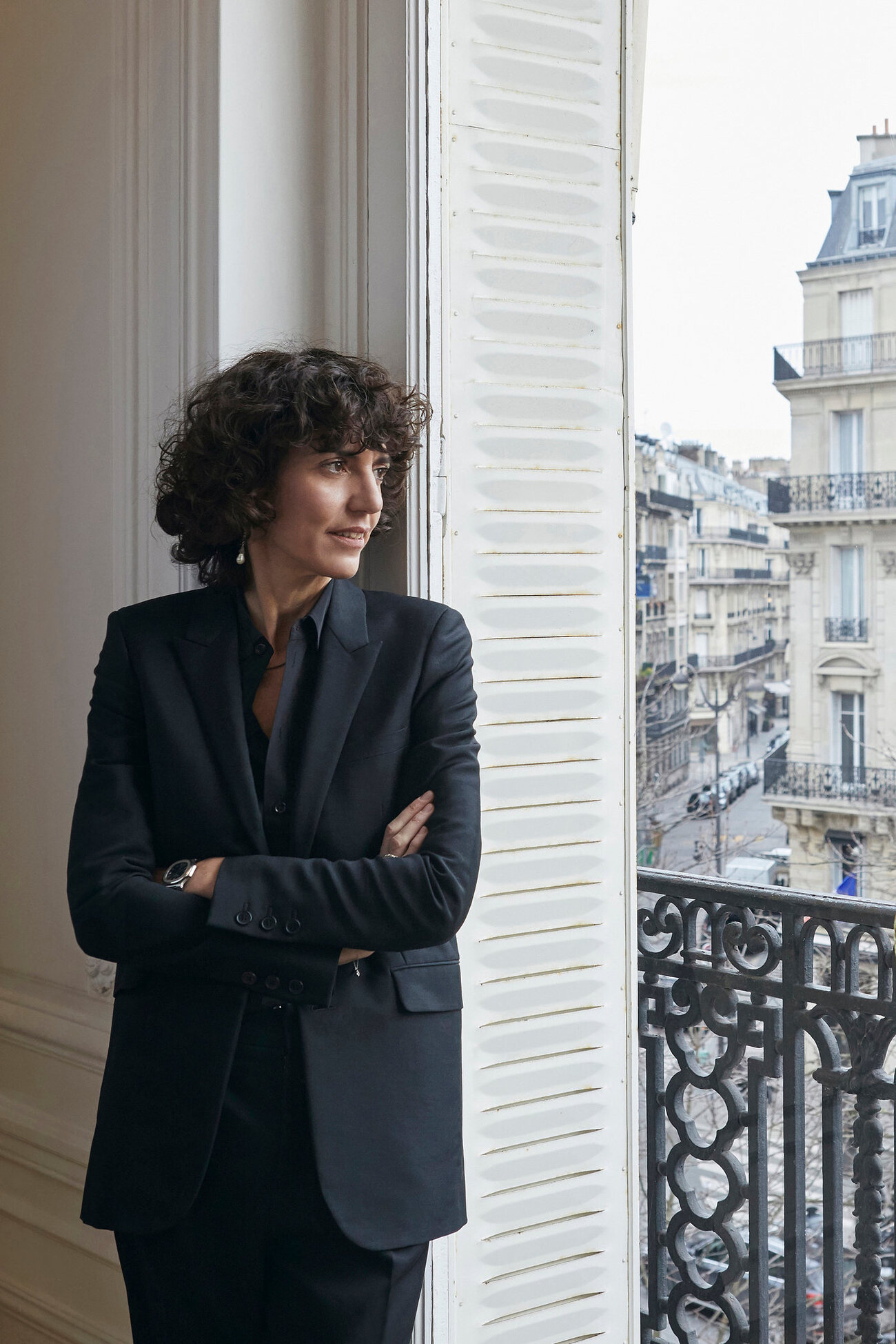 Francesca Bellettini photographed standing beside a window in a formal interior