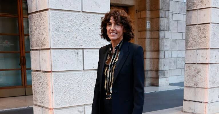 Francesca Bellettini photographed beside a classical stone facade